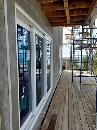 Second-floor deck and new windows on an addition under construction