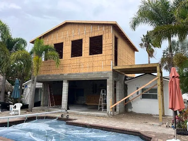 Two-story addition framed and sheathed beside the pool