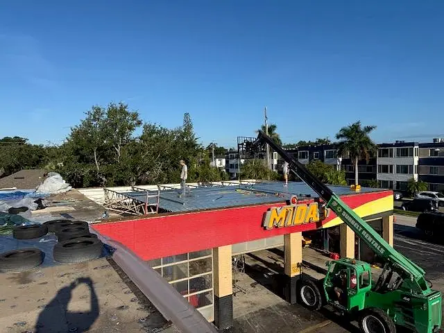Roof replacement on an auto service building, lift on site