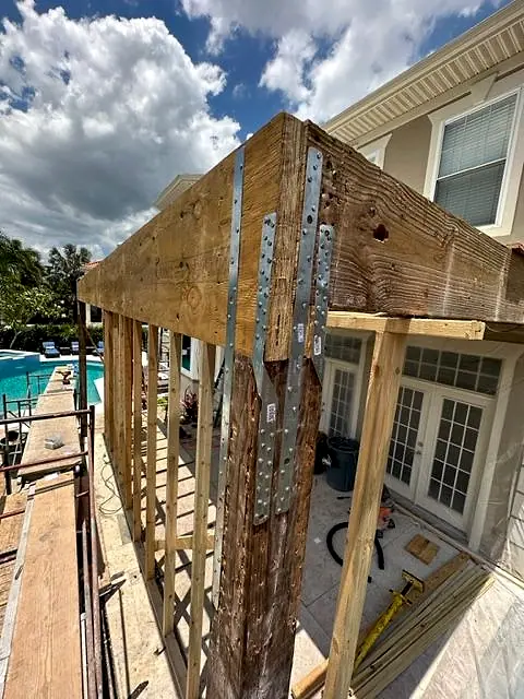 New posts and blocking framed under a rotted balcony beam