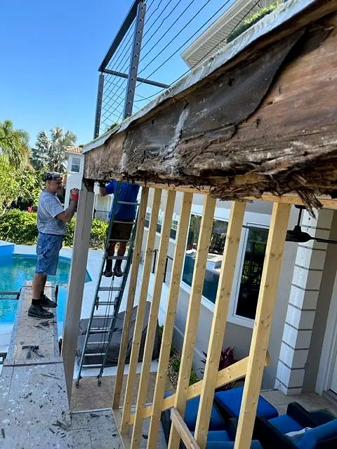 Rotted beam exposed and new framing going in on a pool-deck balcony