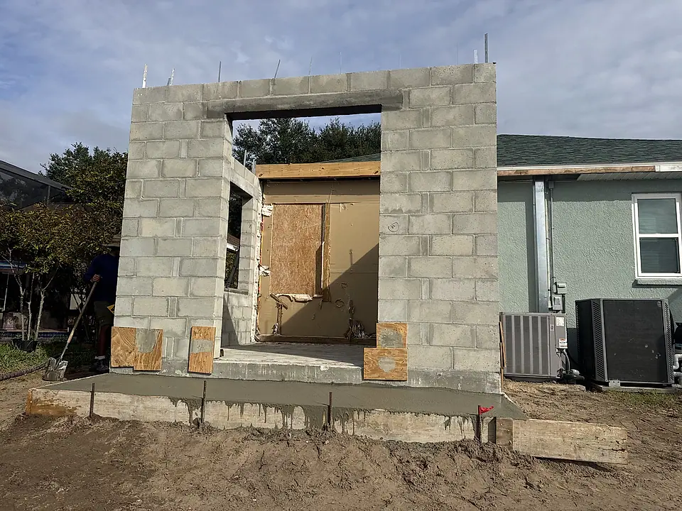 Concrete block addition walls up with door and window openings
