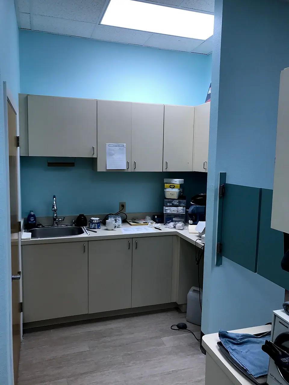 The same break room rebuilt with new cabinets, counters and flooring