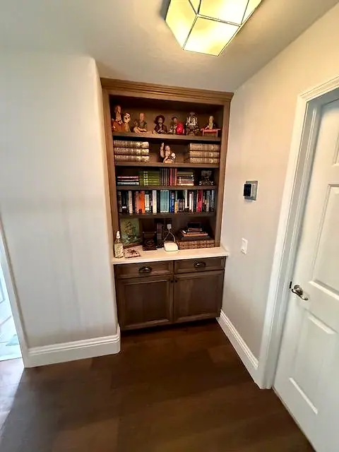 Built-in shelving niche with cabinets in a hallway