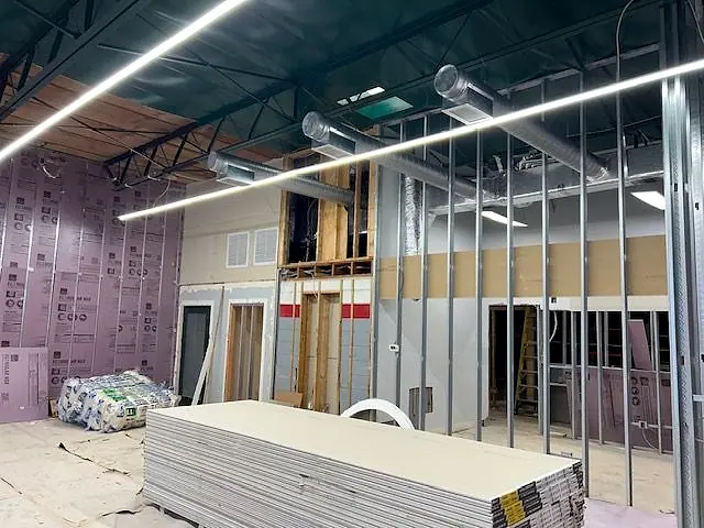 Commercial build-out with metal stud framing, insulation and a linear light fixture