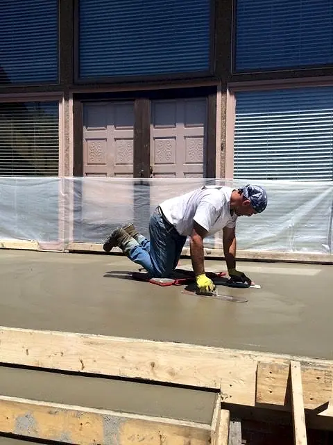 Hand-finishing a new concrete landing