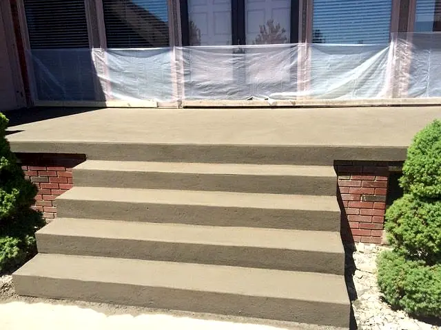 New concrete entry steps with brick cheek walls