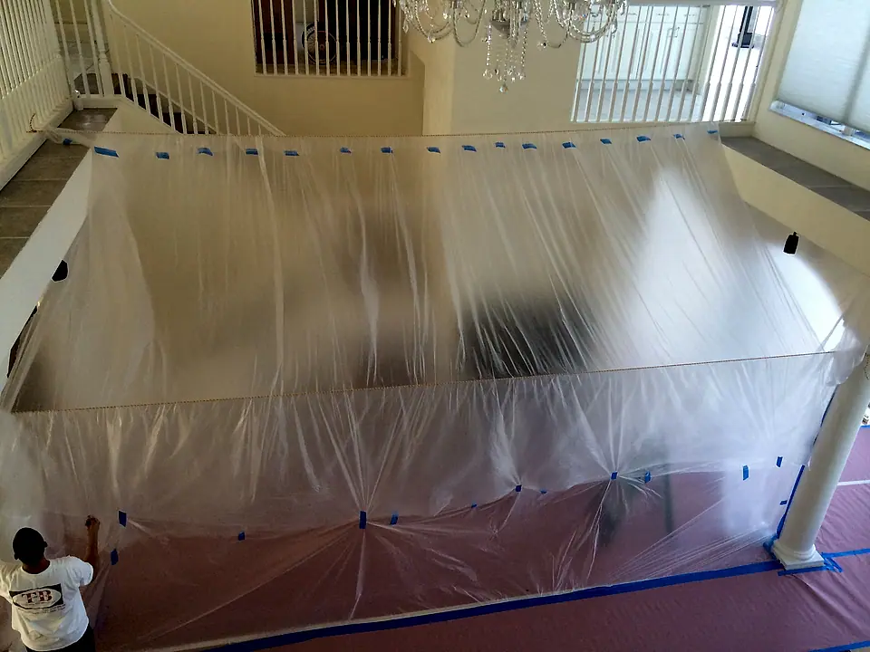 Plastic dust containment hung across an open living area before work starts