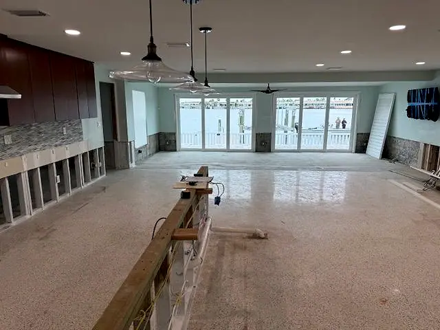 Open great room with the lower walls removed and the floor drying