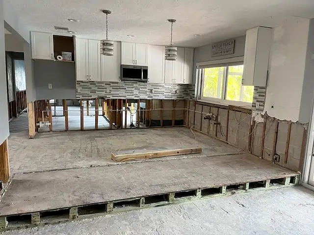 Kitchen with the lower walls and flooring removed after water damage