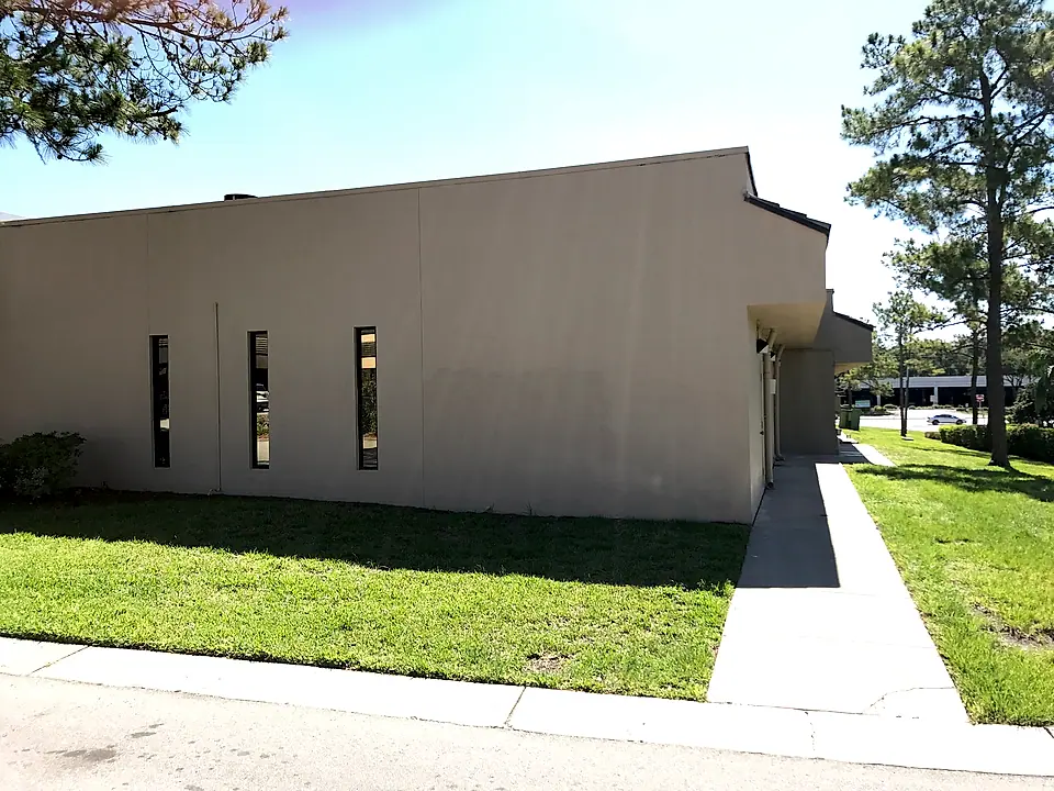 Restored stucco wall along the side of the building