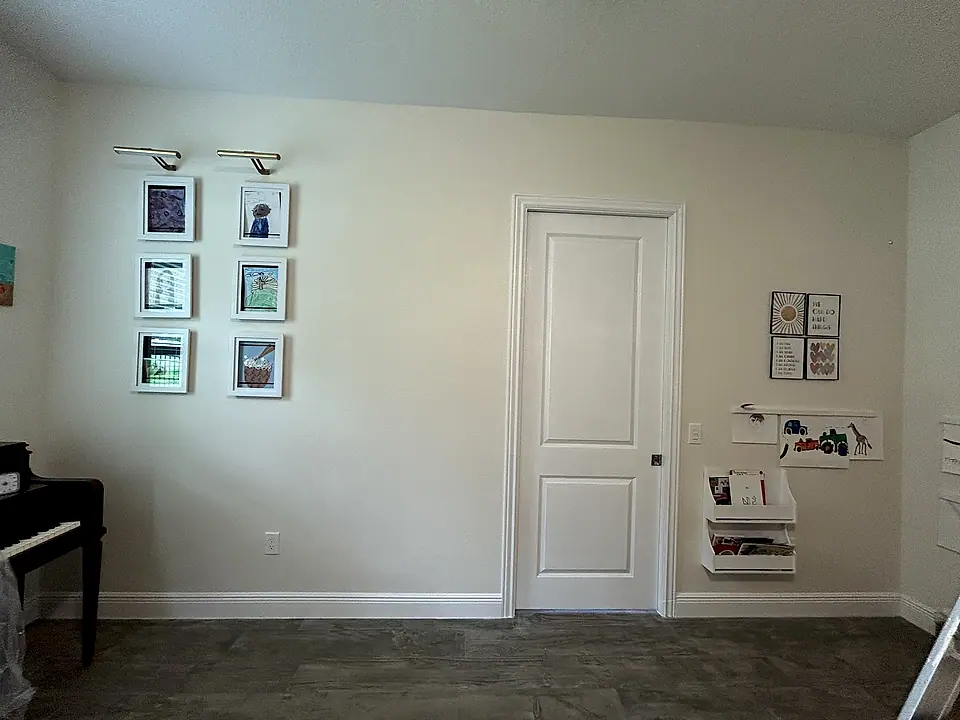 The same room finished, with the wall repaired, a new door and fresh paint