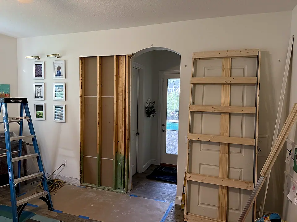 Wall opened to the studs during a repair in a child's room