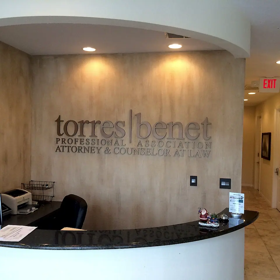 Professional office reception with a curved desk and recessed lighting