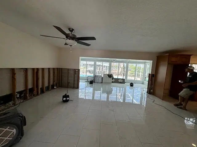 Living room with the lower walls removed and a dehumidifier drying the space