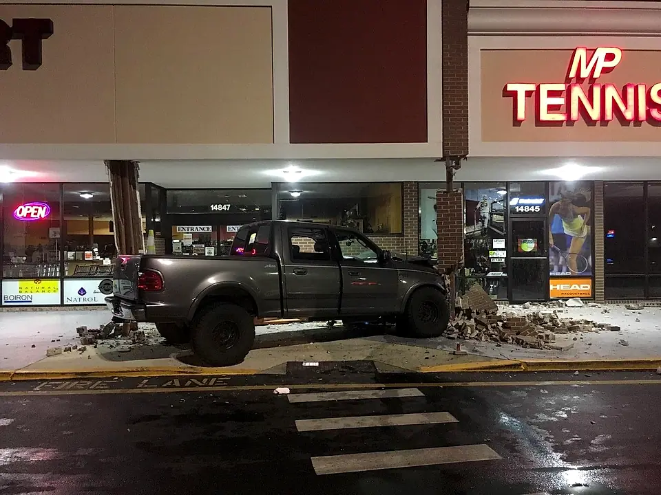 Truck crashed into a storefront column at night