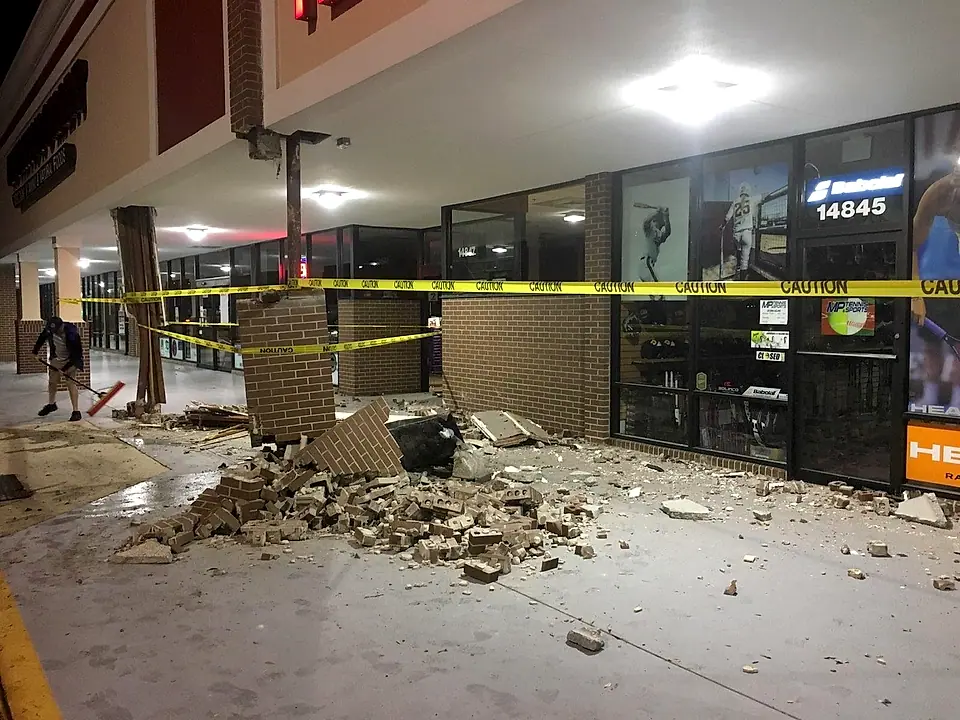 Collapsed brick column and debris after the vehicle impact