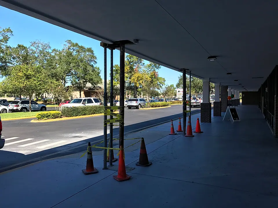 Temporary shoring posts holding up the canopy after the impact