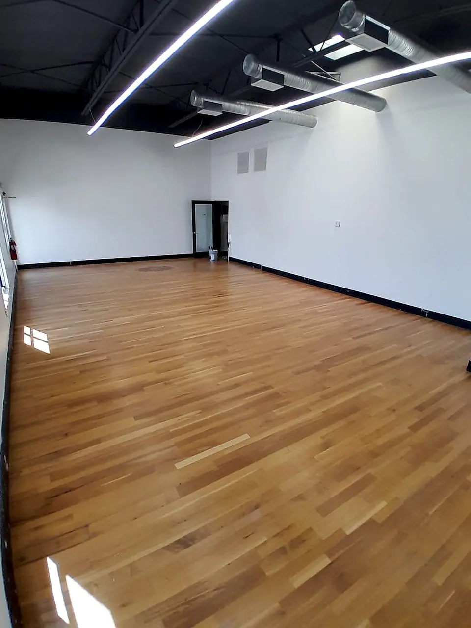 Fresh hardwood floor in an open commercial studio