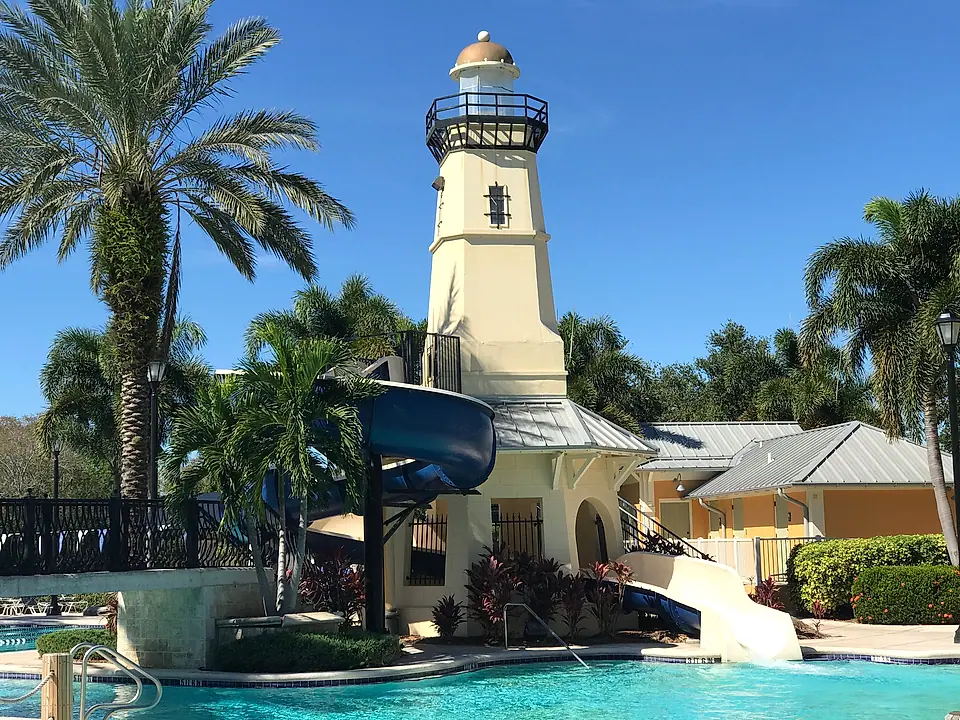 Lighthouse-style water-slide tower at a resort pool