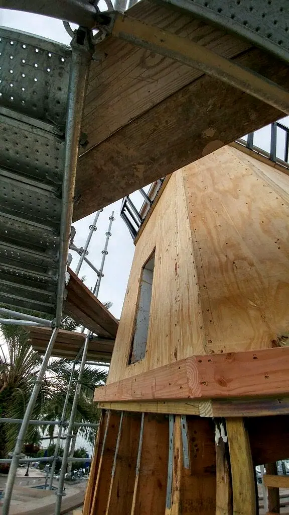 Tower walls sheathed in plywood inside the scaffolding