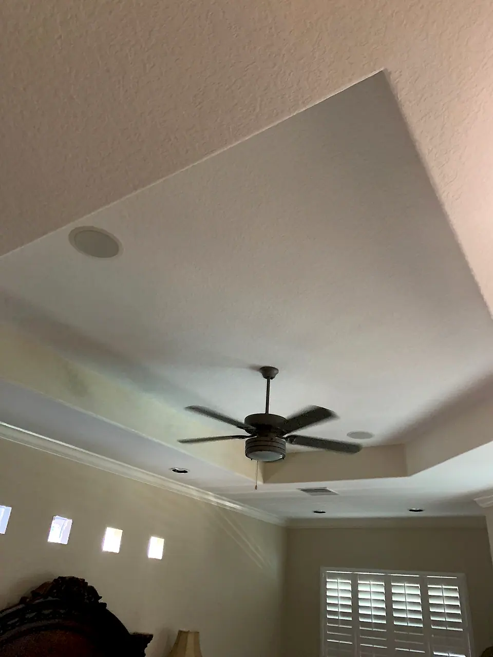 Tray ceiling with a crown detail and ceiling fan