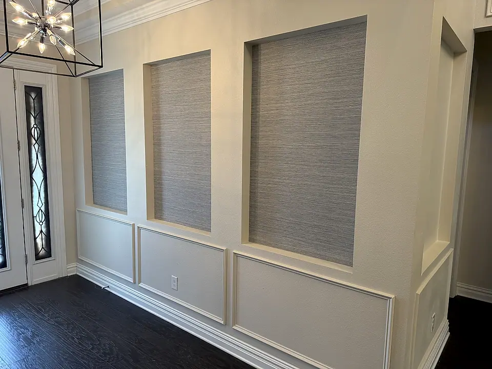 Wainscoting wall with grasscloth panels and dark hardwood floor
