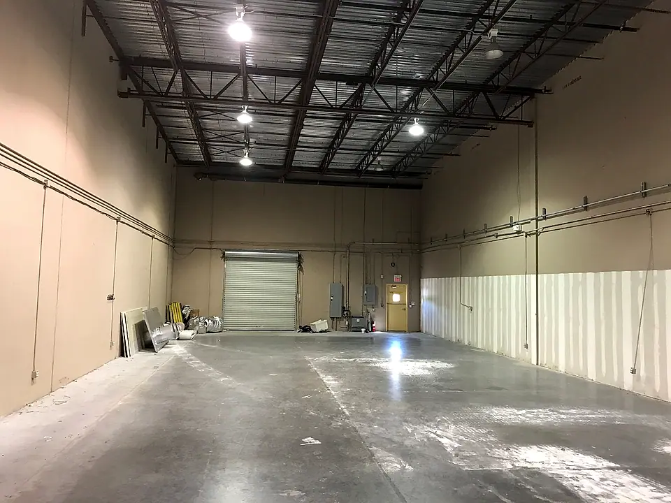 Cleaned and sealed warehouse bay with roll-up door