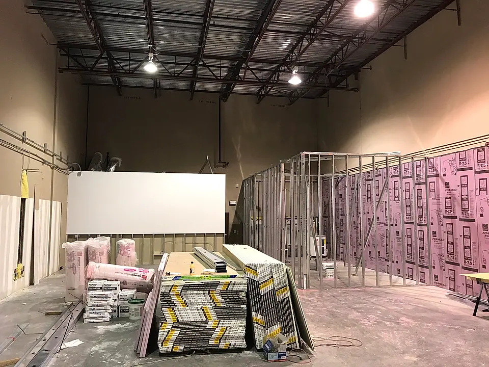 Metal-stud office walls framed inside a warehouse